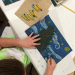 A girl coloring a picture.