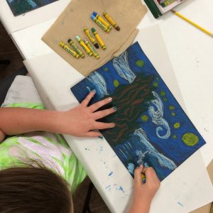 A girl coloring a picture.