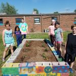 Picture of children standing beside garden