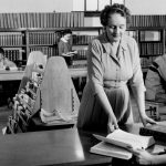 First librarian helping students in 1st library building.