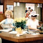 Two staff members working during 65th library birthday party.