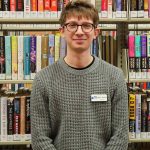 Picture of Jaiden Hedrick in front of shelving